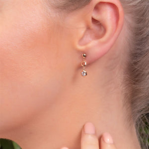 Honeycomb Inspired Clear Sapphire Drop Earrings in 9ct Rose Gold on Model